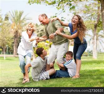 Grandparents having picnic with grandchildren, extended family portrait