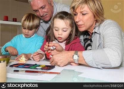 grandparents painting with their grandchildren