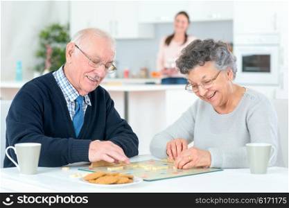 Grandparents playing a board game