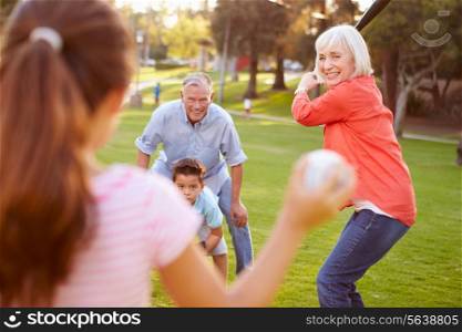 Grandparents Playing Baseball With Grandchildren In Park