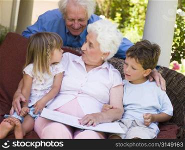 Grandparents reading to grandchildren.