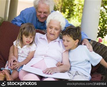 Grandparents reading to grandchildren.
