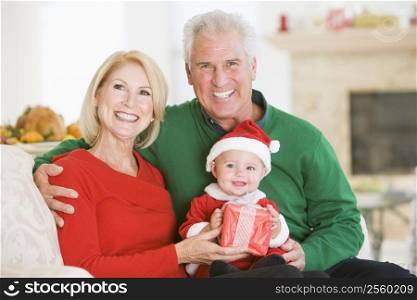 Grandparents With Baby In Santa Outfit