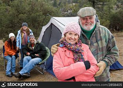 Grandparents with family on camping trip, portrait