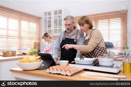 Grandparents with grandχldren and daughter gather in the kitchen to prepare the day’s din≠r.