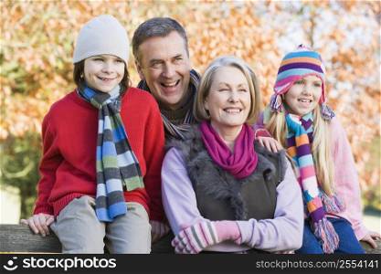 Grandparents with grandchildren outdoors at park smiling (selective focus)