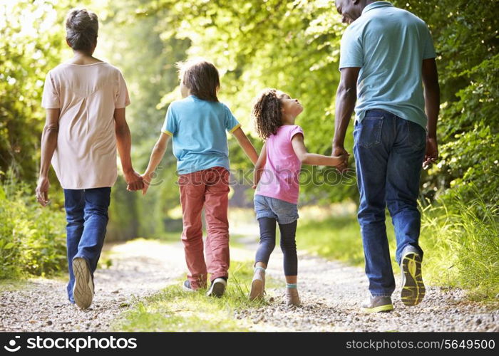 Grandparents With Grandchildren Walking Through Countryside