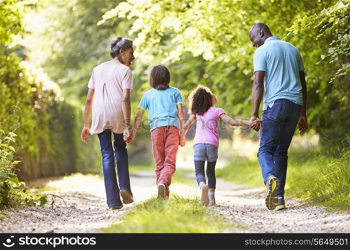 Grandparents With Grandchildren Walking Through Countryside