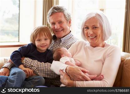 Grandparents With Grandson And Newborn Baby Granddaughter
