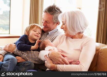 Grandparents With Grandson And Newborn Baby Granddaughter