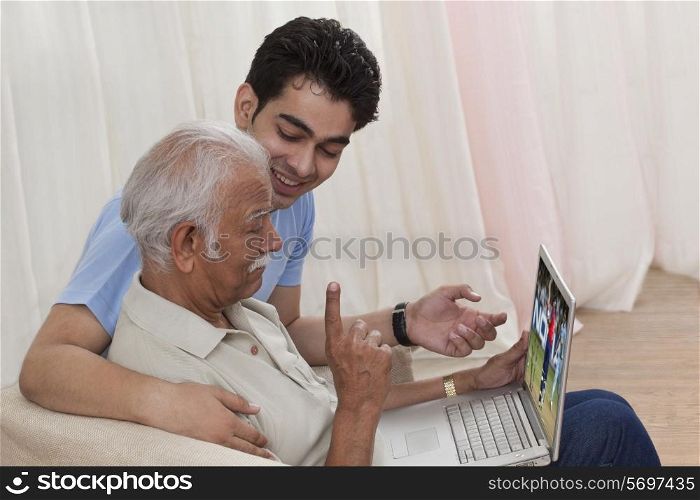 Grandson and grandfather with a laptop