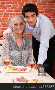 Grandson and grandmother in restaurant