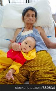 Grandson and grandmother,She is lying sick in bed.