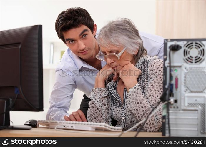 Grandson and grandmother with the computer