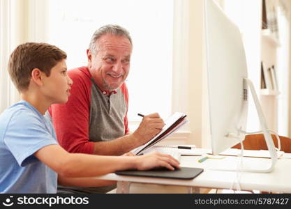 Grandson Teaching Grandfather To Use Computer