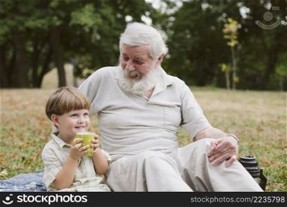 grandson with grandpa drinking tea