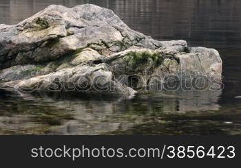 Granite stones in river waves. Time lapse.