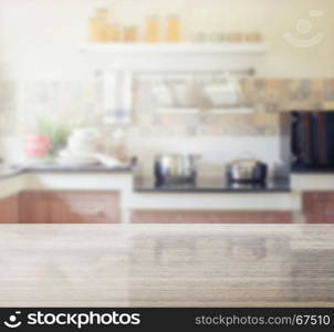 granite table top and blur of modern kitchen interior as background