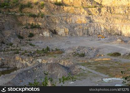 granite walls of stone quarry at the sunset time