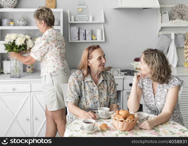 granny grand daughter talking with each other while having breakfast