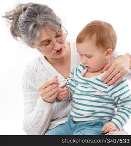 Granny holds grandson and checks his temperature
