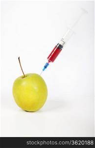 Granny smith apple being injected over white background