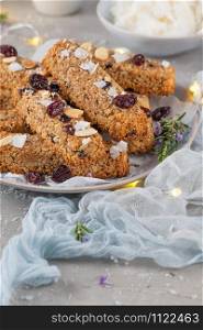 Granola bar. Healthy snack. Cereal granola bar with nuts, fruit, coconut and cranberries on a christmas table.