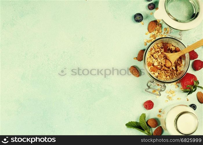 Granola. Breakfast set with granola, almond milk and berries. Healthy eating concept. Copy space background, top view flat lay overhead