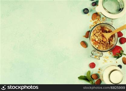 Granola. Breakfast set with granola, almond milk and berries. Healthy eating concept. Copy space background, top view flat lay overhead