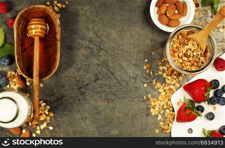 Granola. Breakfast set with granola, almond milk, honey and berries. Healthy eating concept. Copy space background, top view flat lay overhead