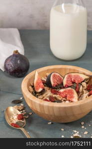 Granola for healthy breakfast. Bowl with granola , milk , fresh fig and dried berries