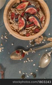 Granola for healthy breakfast. Bowl with granola , milk , fresh fig and dried berries