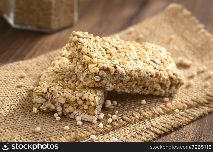 Granola or cereal bars made of popped quinoa, sesame seed, popped rice, sunflower seed, chia and honey, photographed with natural light (Selective Focus, Focus on the front edge of the upper bar)