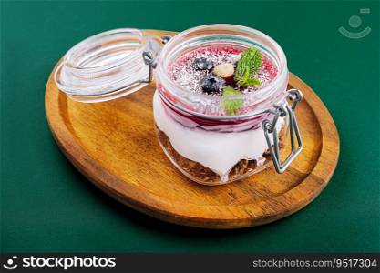 Granola with nuts, yogurt and fruits berries in a jar