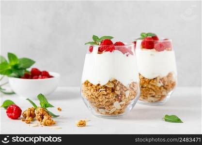 Granola with white plain yogurt and raspberry in a glass