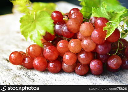 Grape and leaves on a wooden stand