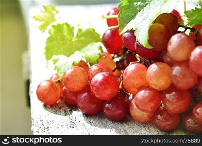 Grape and leaves on a wooden stand