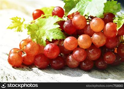 Grape and leaves on a wooden stand