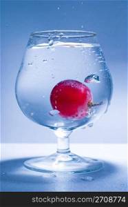 grape fall into glass water, frozen motion