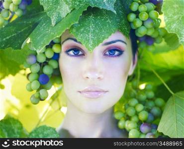 Grape goddess. Beautiful young lady wrapped in grape