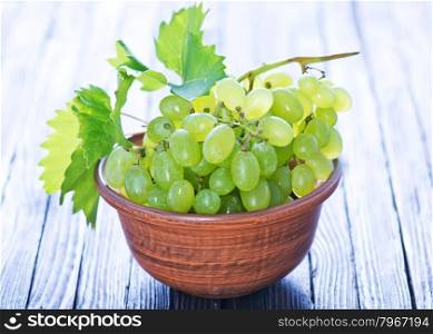 grape in bowl and on a table