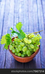 grape in bowl and on a table