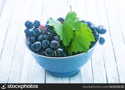 grape in bowl and on a table