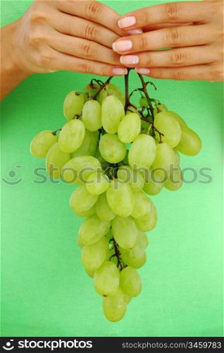 grape in woman hands close up