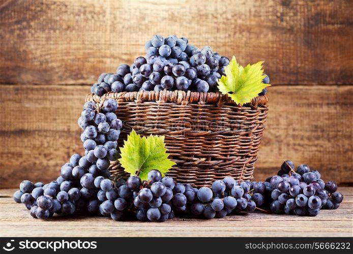 grape in wooden basket on wooden background