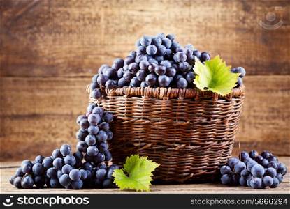 grape in wooden basket on wooden background