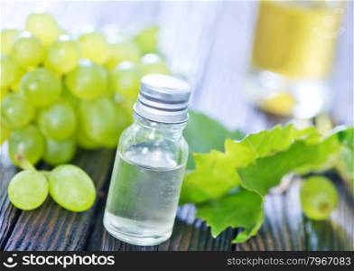grape oil in bottle and on a table