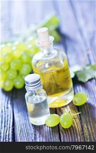 grape oil in bottle and on a table