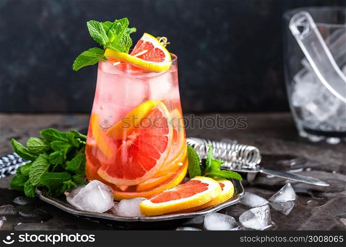 Grapefruit and fresh mint cocktail with juice, cold summer citrus refreshing drink or beverage with ice