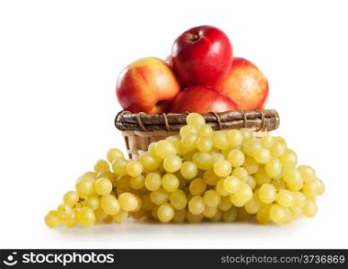 Grapes and apples in a basket isolated on white background